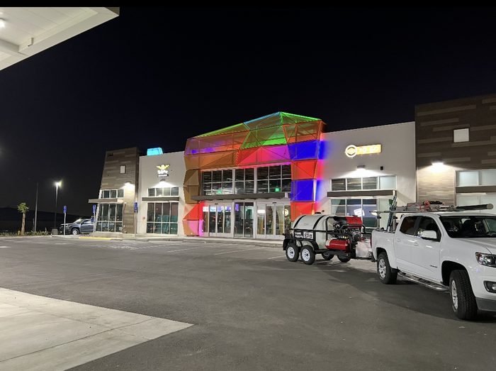 Large illuminated commercial center with service vehicles
